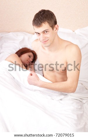 Young Man Thumbs Up while Woman Sleeps