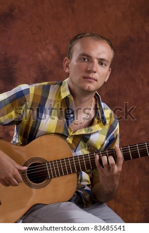 Young man playing classic spanish guitar