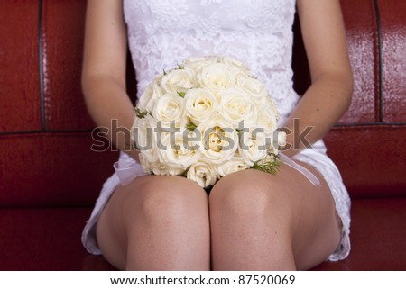 stock photo wedding bridal bouquet of white roses lay on his knees on a