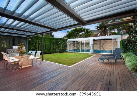 a beautiful courtyard with a lawn and swimming pool . barbecue area .
