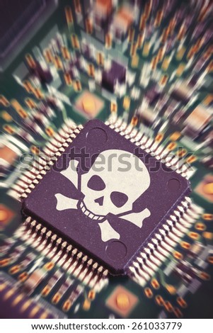 Macro shot of a circuit board with big microchip carrying a pirate symbol