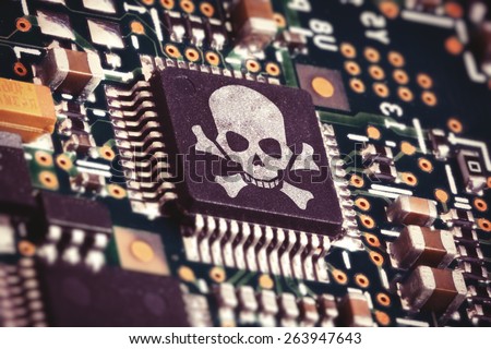 Macro photo of a circuit board with microchip carrying a pirate symbol