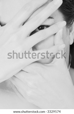 Mysterious woman holding hands in front of her face