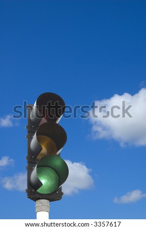 Traffic lights - green light on in front of blue sky