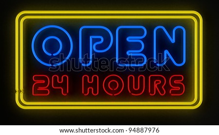 Neon sign displaying open 24 hours over dark reflective surface