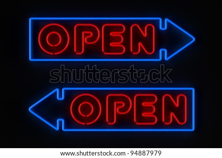 Neon sign with arrow showing an open store