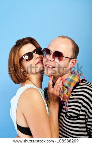 woman and man together with sunglasses on blue background