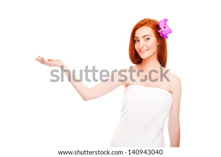 Woman in towel smiling holding something in hand