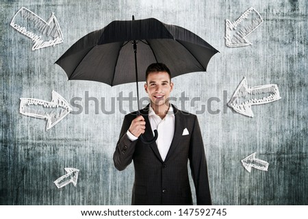 man by the wall with umbrella in his hand