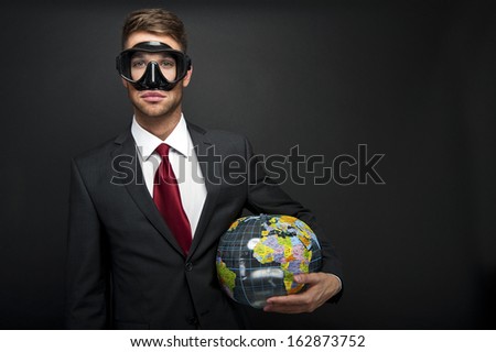 Businessman with world globe and diving mask