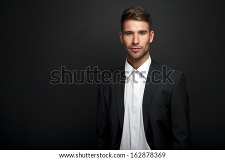 Businessman standing on dark gradient background