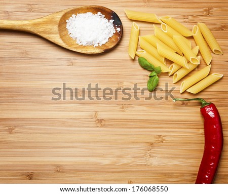 Serving spoons on checkered cloth lying on wooden surface