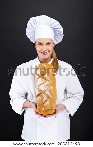 chef woman over dark background smiling and ckoking