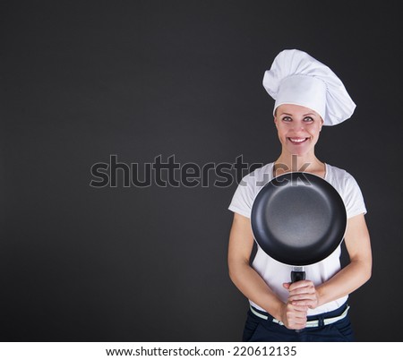 cooking and food concept - smiling female chef, cook or baker with pan