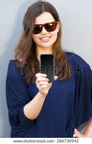 Cheerful woman talking photo on the phone in the street casual outfit. hand focus