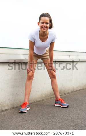 Focused runner outdoors resting with big smile