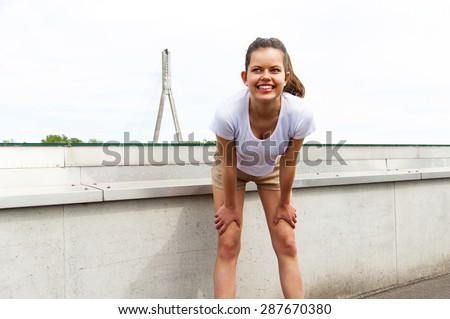 Focused runner outdoors resting with big smile