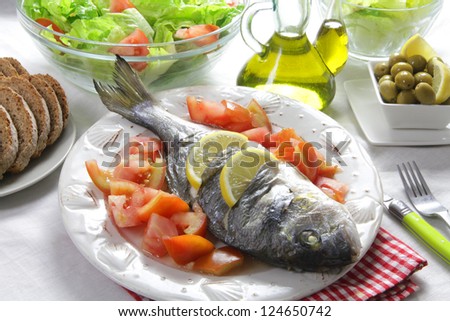 grilled gilt head bream with tomato salad olive oil and olives. Healthy mediterranean diet