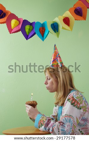 a woman bowing out her birthday candle. Lonely