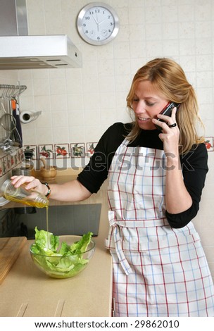 woman dressing a salad with olive oil