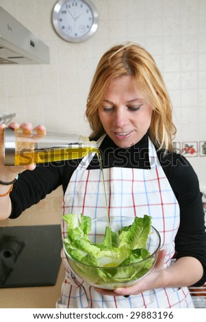 woman dressing a green salad