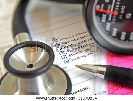 sphygmomanometer, stethoscope and physical exam chart