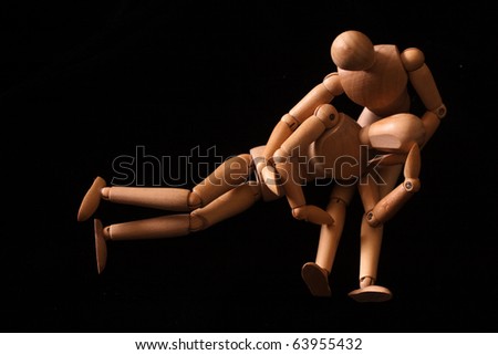 wooden model toy dolls in a sad pose in color