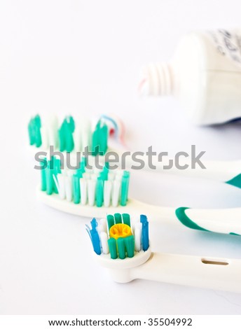 a tooth brush is electric with tooth-paste