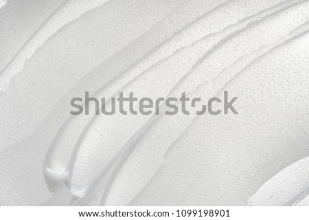 White smear of cosmetic cream isolated on white background. Creamy foundation texture isolated. Smear of face cream isolated. Texture of cream background