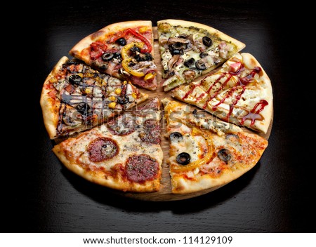 six slices of pizza with different toppings on a wooden board on black background