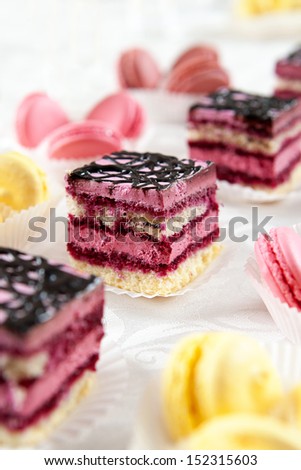 Buffet served sweets, colorful macaroons and biscuit cakes