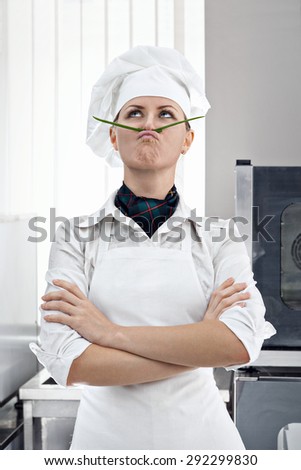 Professional female chef with a mustache of green onion copies of Salvador Dali