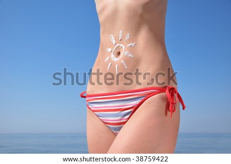 tummy with sun-shaped sun cream