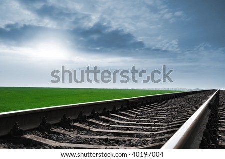 The railway leaving in a distance under the blue sky