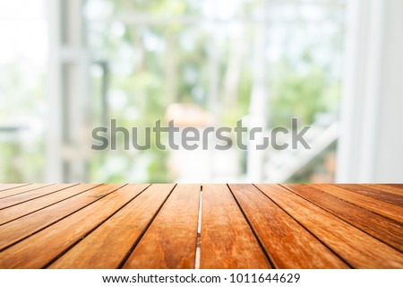 Wooden board empty table in front of blurred background. Perspective light wood over blur in window or door interior- can be used for display or montage your products. Mock up for display of product.
