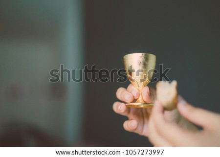 Holy communion in church.Taking holy Communion.Cup of glass with red wine, bread.The Feast of Corpus Christi Concept.
