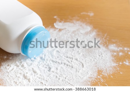 Baby talcum powder container on wooden background