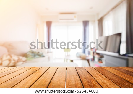 Wooden board empty table in front of blurred background. Perspective light wood over blur in living room interior- can be used for display or montage your products. Mock up for display of product.