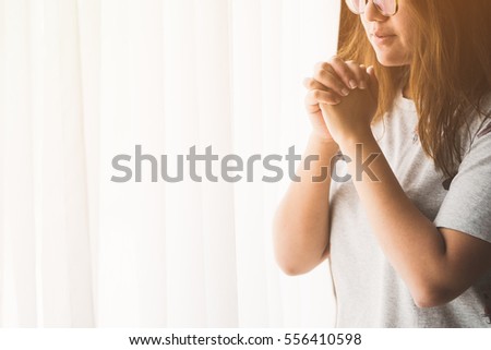 woman praying near the window in the morning.teenager woman hand praying,Hands folded in prayer near the window in the morning concept for faith, spirituality and religion