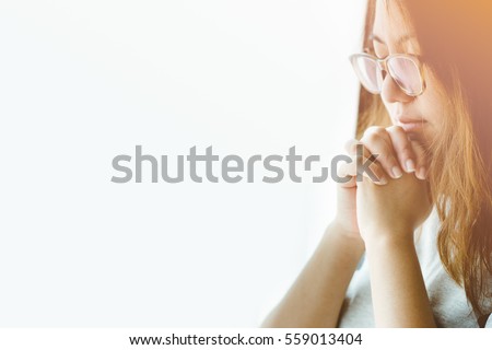woman praying near the window in the morning.teenager woman hand praying,Hands folded in prayer near the window in the morning concept for faith, spirituality and religion