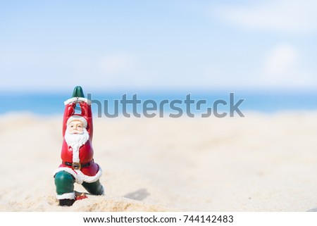 Christmas Santa claus practicing yoga at the ocean tropical sandy beach for ready back to work in Christmas night.Santa on the beach.