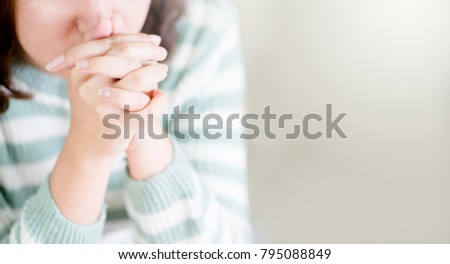 woman praying on holy bible in the morning.teenager woman hand with Bible praying,Hands folded in prayer on a Holy Bible in church concept for faith, spirituality and religion