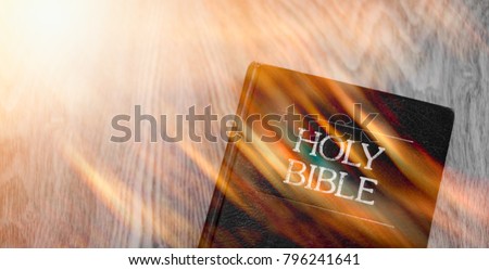 The Holy Bible and Holy spirit on fire come wooden background.Holy spirit and read bible and anointing concept.