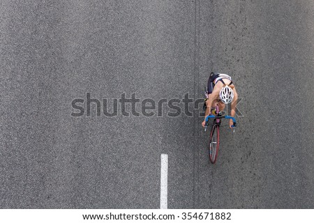 Bike on the asphalt road, top view