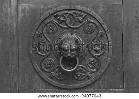 Grunge medieval background - rusty antique door knocker
