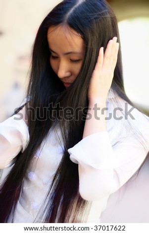 Asian girl covered ears with her hands