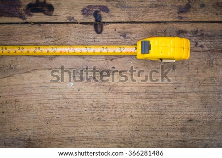 tape measure,tape measure on the brown wooden background