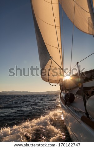 Sailboat crop during the regatta at sunset ocean