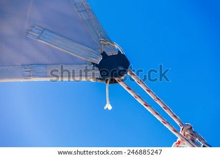 rope, knot and piece of sail isolated on blue on sailing boat