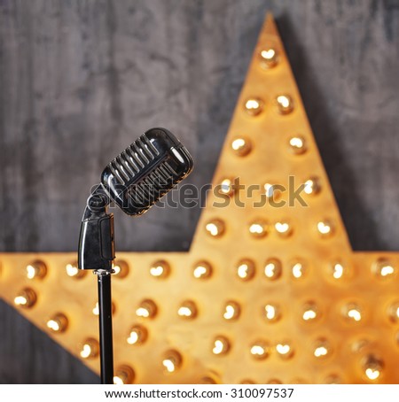Vintage microphone in studio with star on background